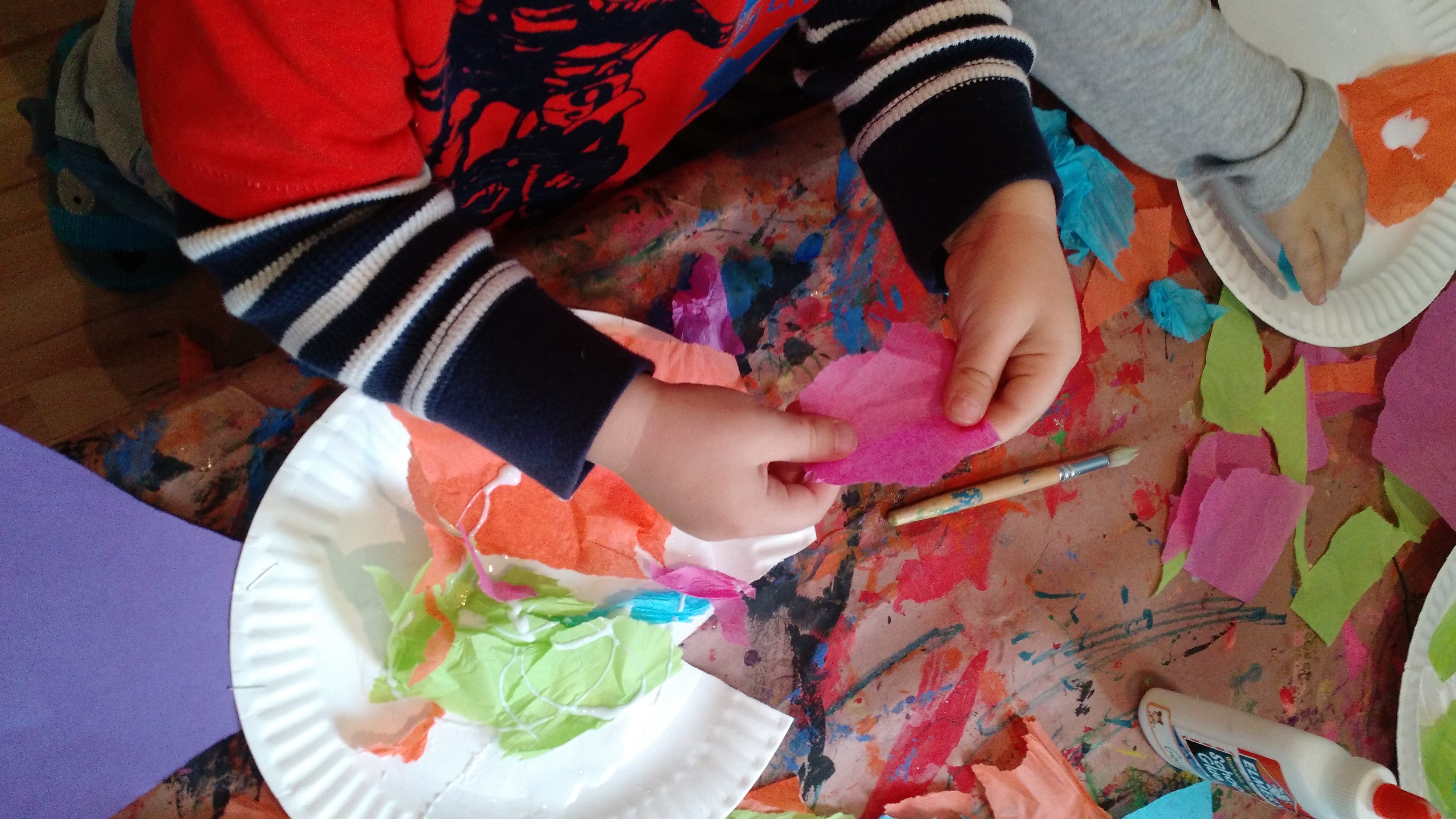 child playing with art and craft