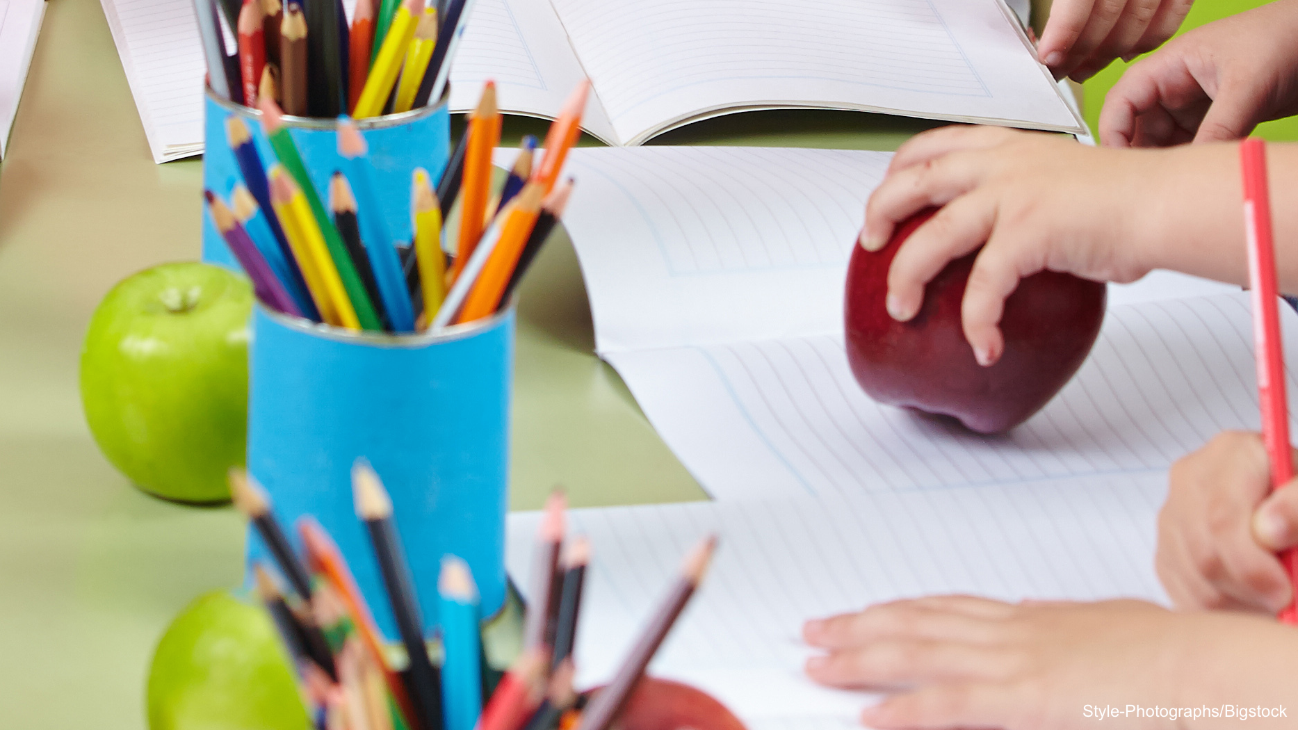 coloring pencils and copy with an apple