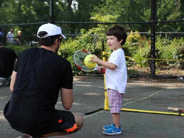 Child taking tennis lesson